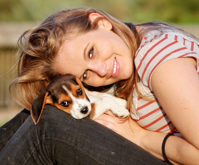 Woman and puppy smiling