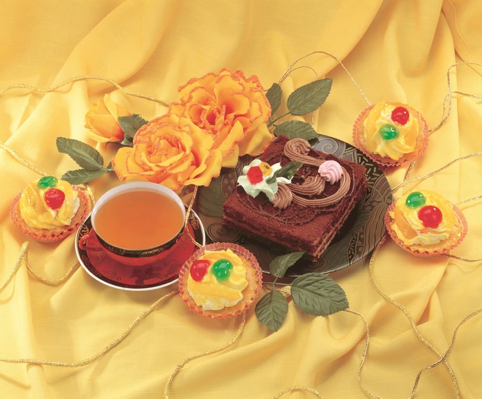 Still-life with tea, cakes, and roses