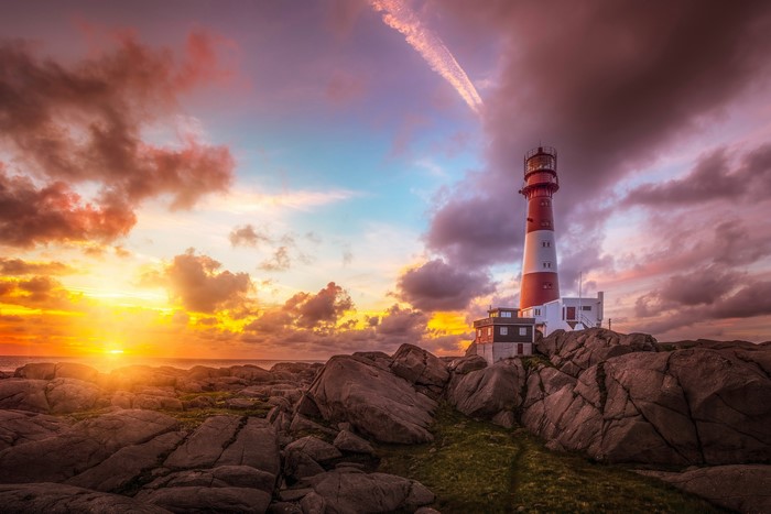 Lighthouse on rocky coast at sunset, Nymark Rogaland, Norway