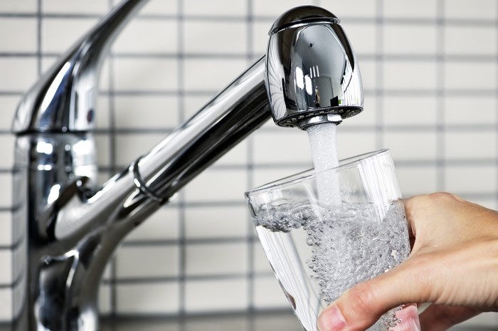 Water pouring from a tap into a glass