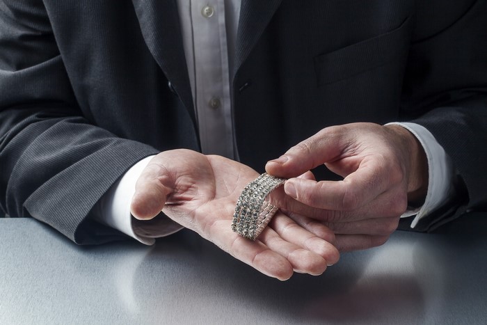 Man in Suit Showing Diamond Bracelet