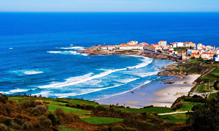 Coastline with town and waves in Galicia, Spain