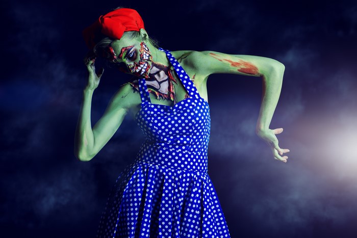 Zombie woman in polka dot dress and red hat