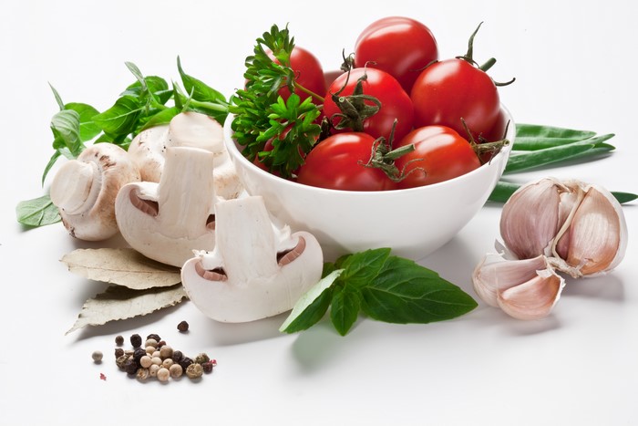 Tomatoes, Mushrooms, Garlic, and Spices on White Background