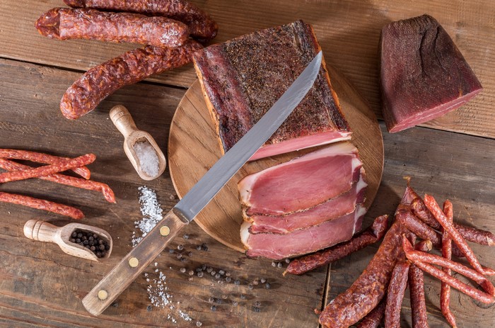 Meat products with knife, salt, and pepper