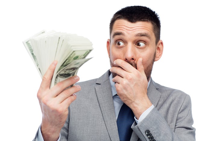 Man in Suit Holding Stack of Money