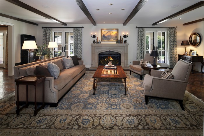 Living room with sofa, armchairs, fireplace, and carpet