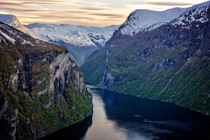 Geirangerfjord, Norway with snow-capped mountains and waterfalls