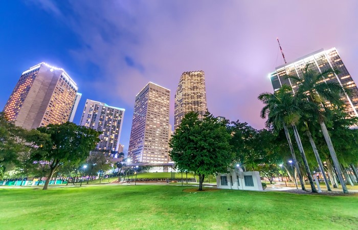 Miami skyscrapers at dusk with park in foreground