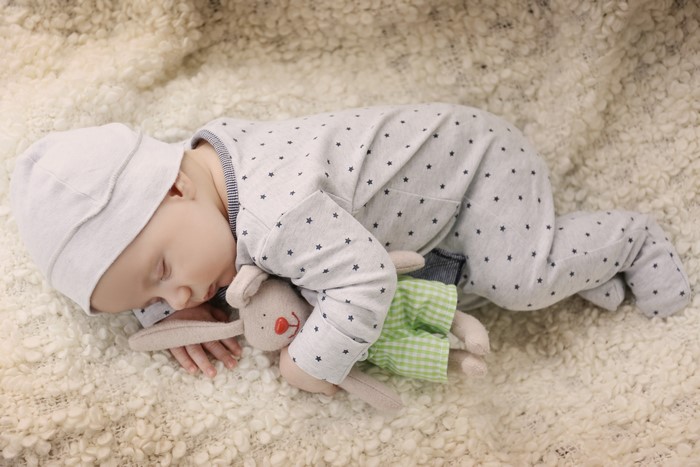 Infant sleeping with a toy bunny
