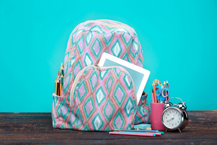 Backpack with school supplies and alarm clock