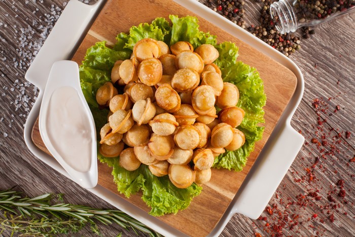 Fried Pelmeni on Lettuce with Sauce