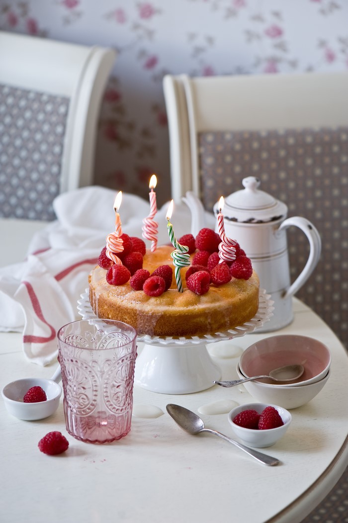 Birthday cake with raspberries and candles