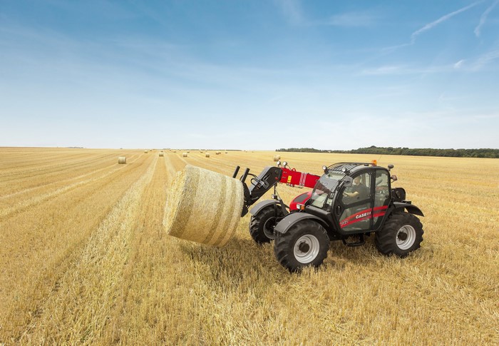 Case IH Farmlift 742 telehandler collecting hay bale