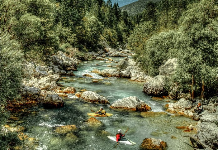 Kayakers on a rocky river in Slovenia