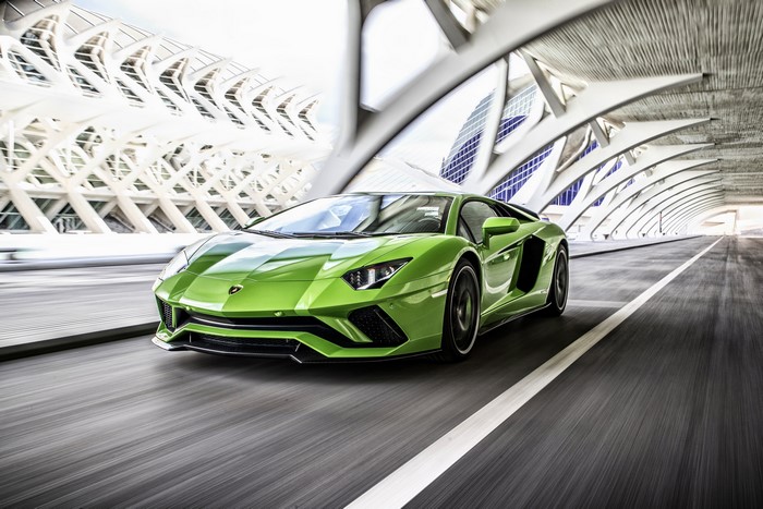 Green Lamborghini Aventador S driving on road