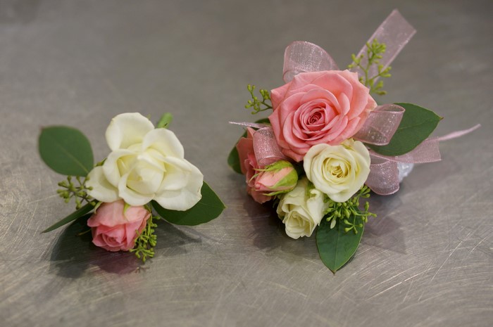 Two floral arrangements with roses and greenery