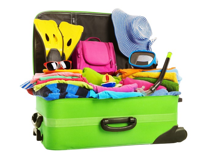 Open suitcase packed with travel items