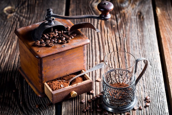 Coffee mill with coffee beans and grounds
