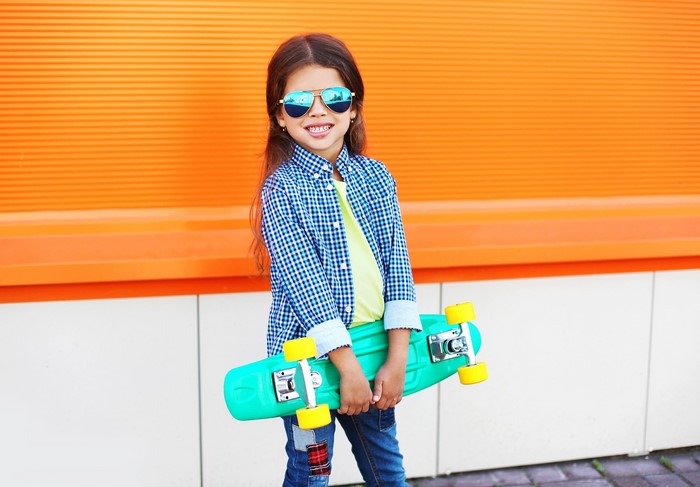Girl with skateboard and sunglasses