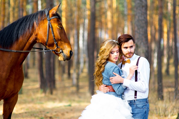 Couple with horse in forest