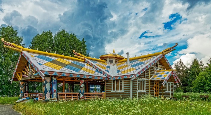 Wooden house with dragon-shaped roof in Mandrogi, Russia