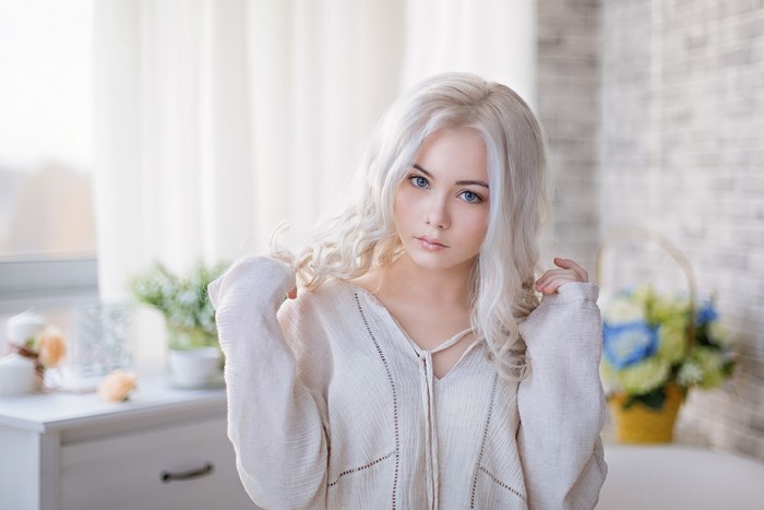 Blonde girl with blue eyes looking at camera