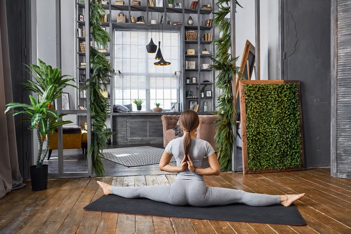Woman Doing Split Yoga Pose Indoors