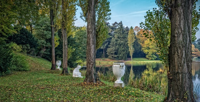 Park with pond, sculptures, and trees in Worlitz, Germany