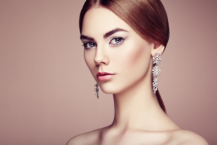 Woman with long earrings and makeup