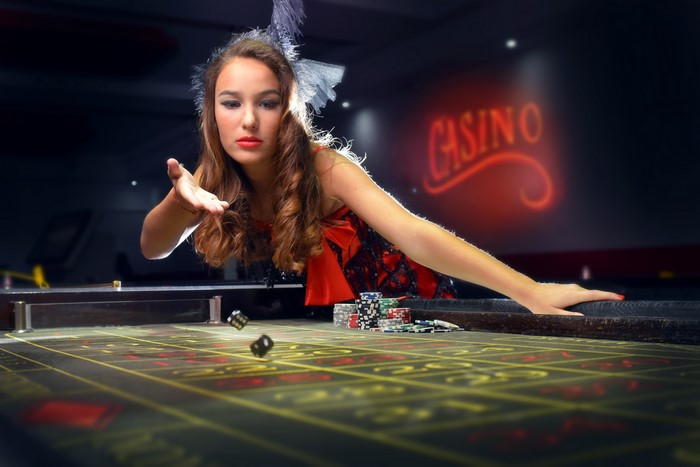 Woman throwing dice at a casino table