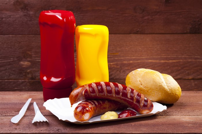 Sausages with Buns and Condiments on Wood