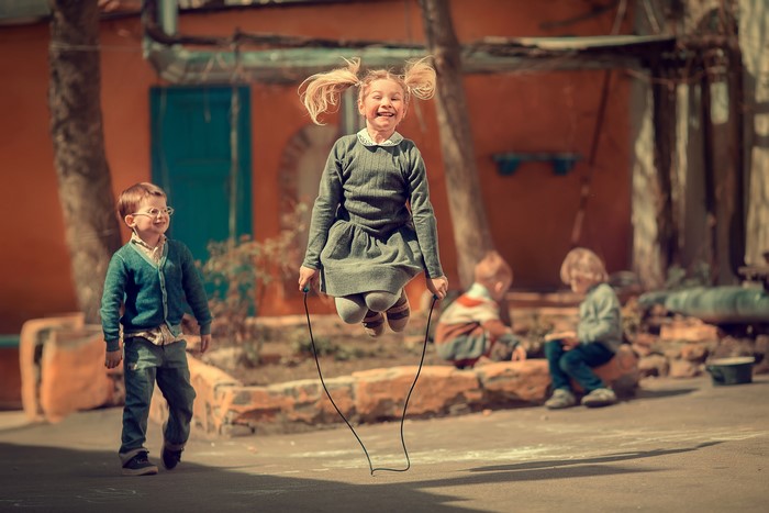 Children playing jump rope outdoors