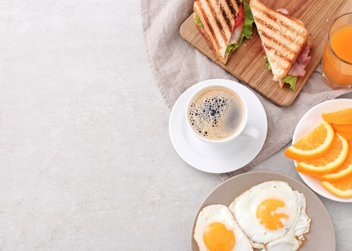 Breakfast with Coffee, Sandwich, Fried Eggs, and Orange Juice
