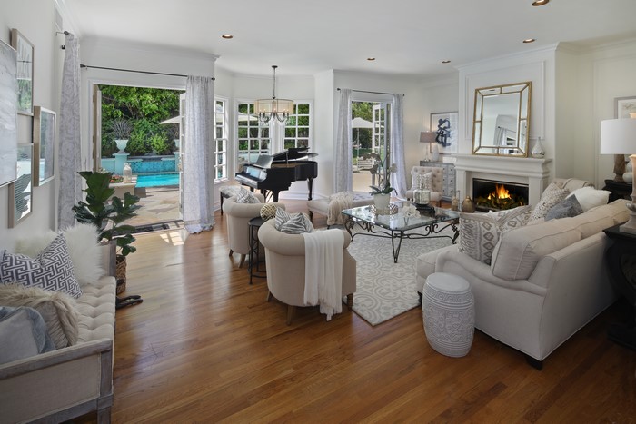Living room with piano and pool view