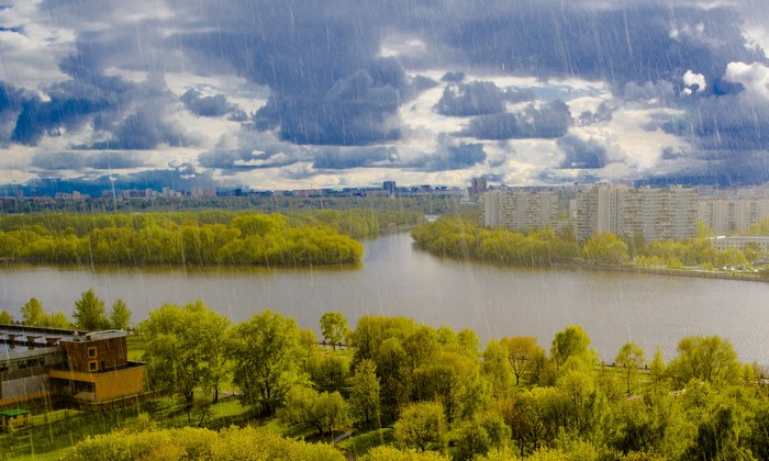 Rain over Moscow River with city and clouds