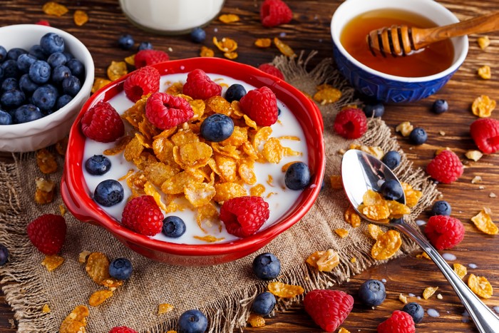 Breakfast with Corn Flakes, Raspberries, Blueberries, and Honey