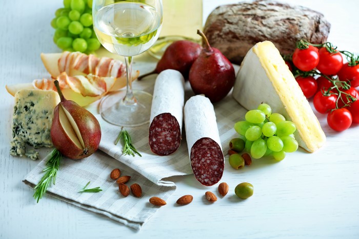 Still-life of sausage, cheese, pears, grapes, and wine
