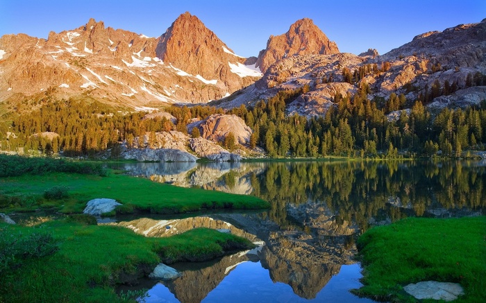 Mountain peaks reflected in a lake at sunrise