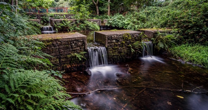 Stone and concrete water cascades in a forest