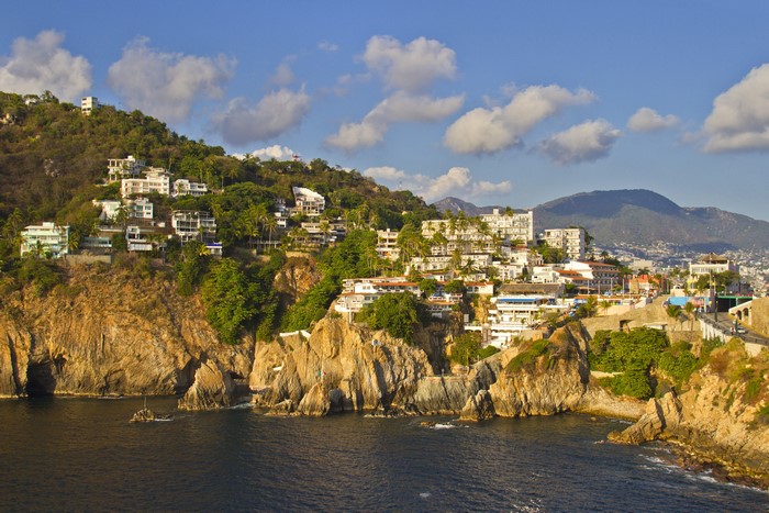 Houses on a cliffside overlooking the bay in Acapulco, Mexico