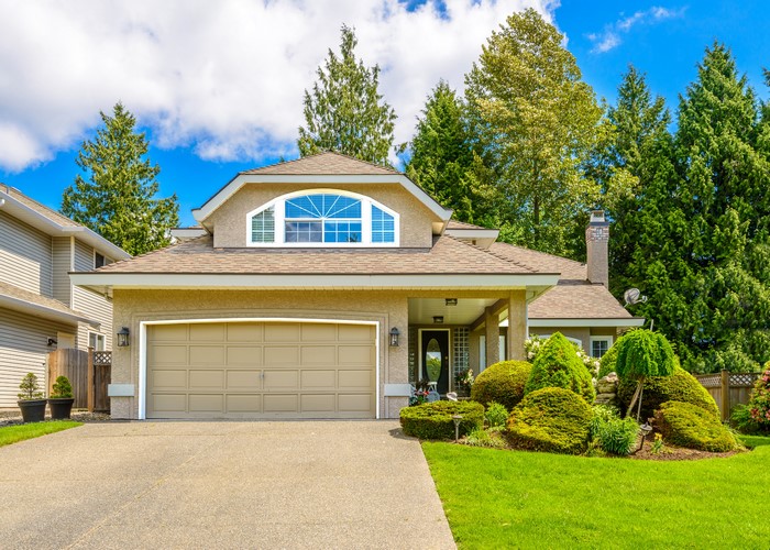 Suburban house with garage and manicured landscaping