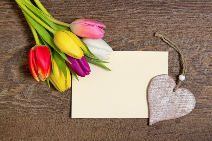 Tulips and Heart Decoration on Wooden Background