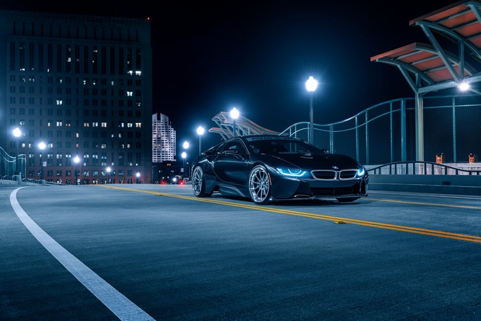 Black BMW i8 on a bridge at night