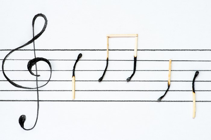 Burning Matches as Musical Notes on Staff Paper