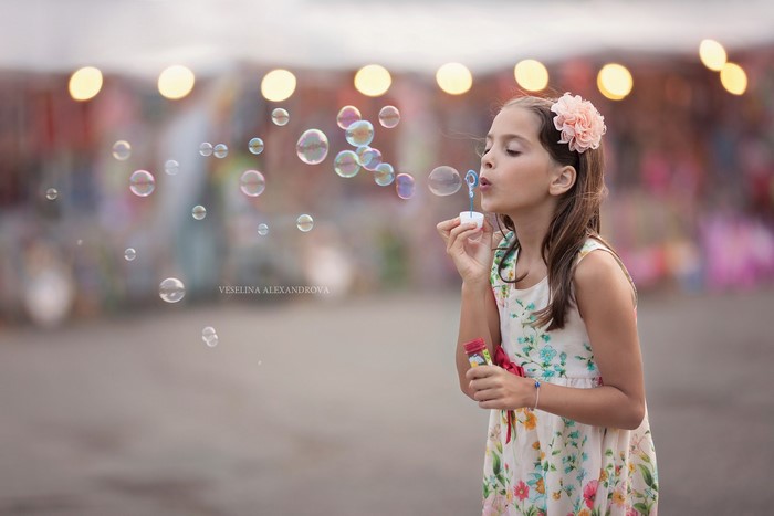 Girl blowing soap bubbles