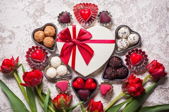 Valentine's Day heart-shaped gift box with chocolates and tulips