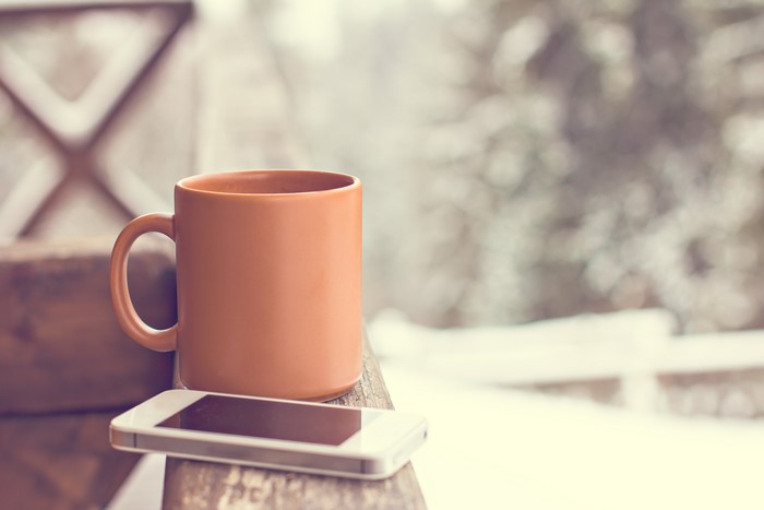 Mug and Smartphone on a Wooden Surface