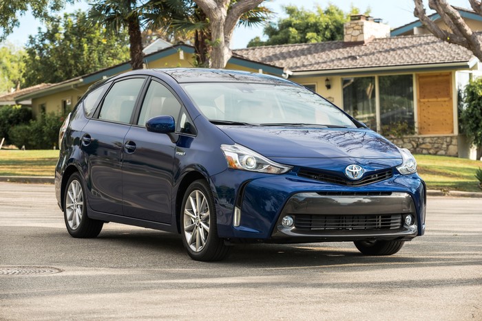 Blue 2016 Toyota Prius v parked on a street