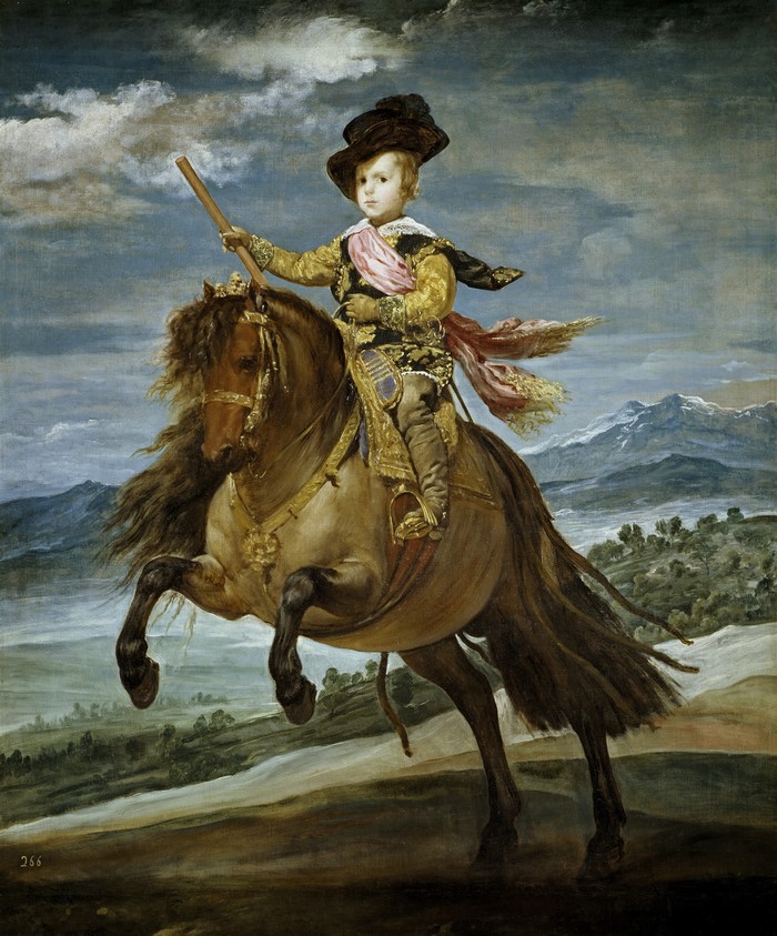 Equestrian portrait of a young boy in a landscape
